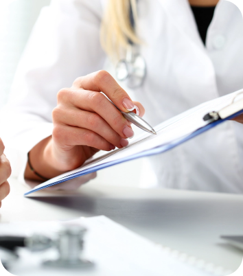 Doctor writing on clipboard